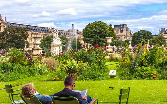 two people relaxing in chairs at tuileries garden in paris france