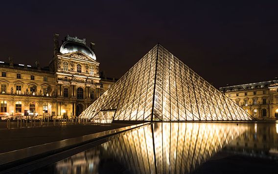 the louvre in paris lit up at night