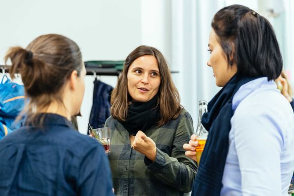 people talking during event | Image by ©