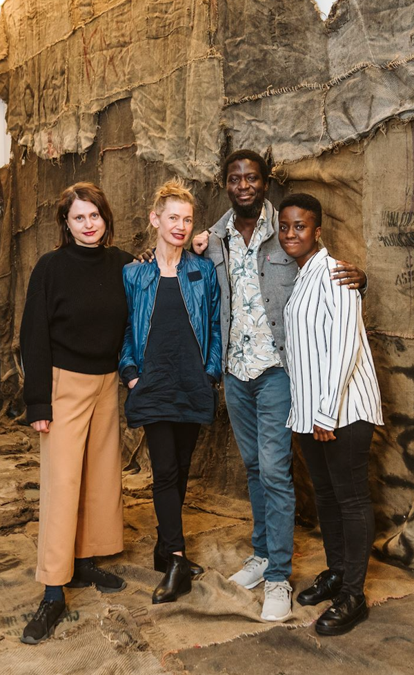 Elisabeth Falkensteiner Baerbel Mueller, Ibrahim Mahama and Tracy Thompson in the exhibition in front of the work by Ibrahim Mahama  | Image by ©