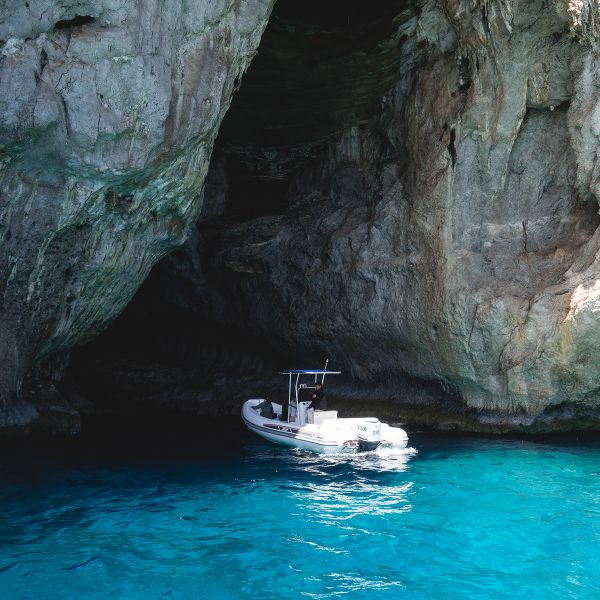 Small boat among rocks in Capri Italy