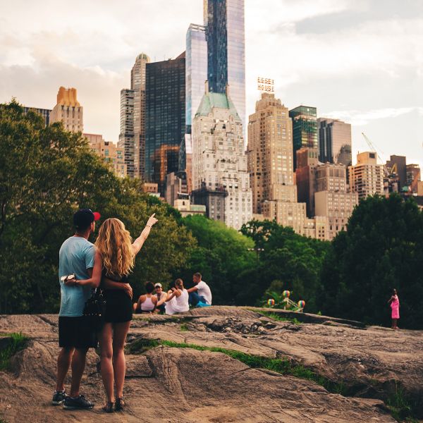 young couple take in the city skyline in central park