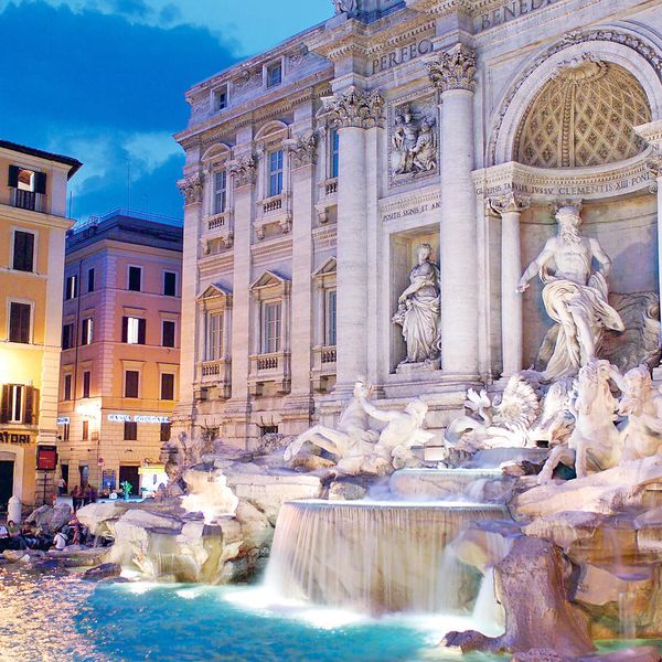 people surrounding the trevi fountain in rome italy during evening