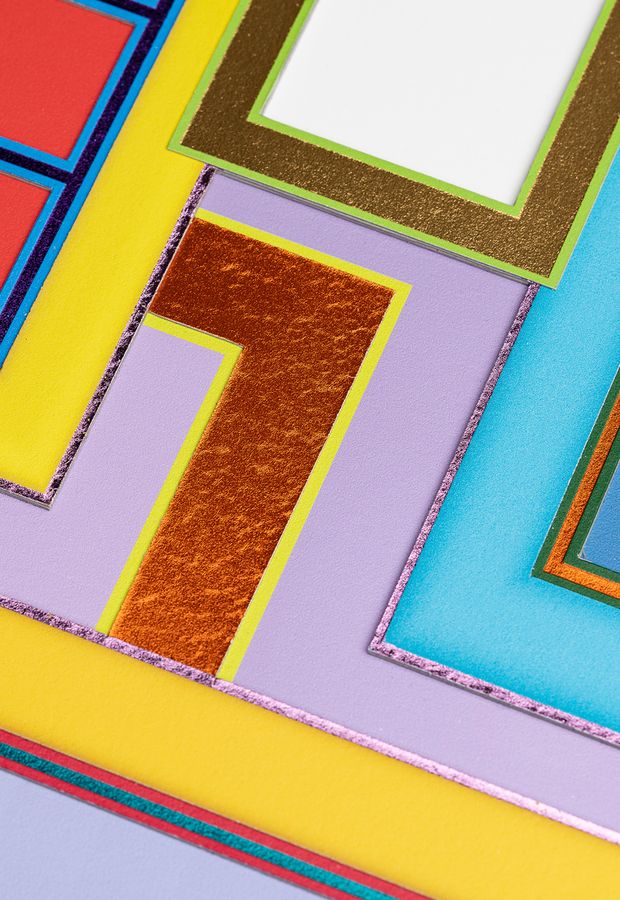 on-angle close up of a colourful, rectilinear print centred on an l-shaped section of metallic orange