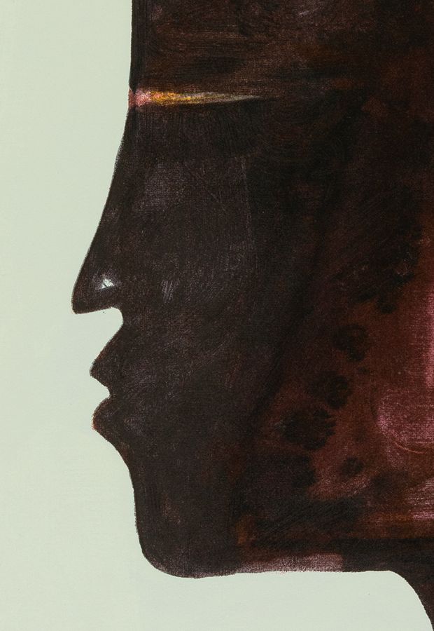 close up of a deep red painted face in profile