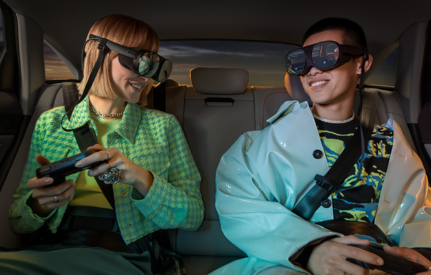 girl and boy in the backseat with headsets on and gamepads playing