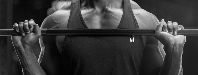 A man wearing a Myprotein shirt lifting a barbell