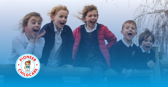 Happy children all smiling at the camera in their school uniforms. Image has a blue overlay with a gradient and the Pioneer Childcare logo