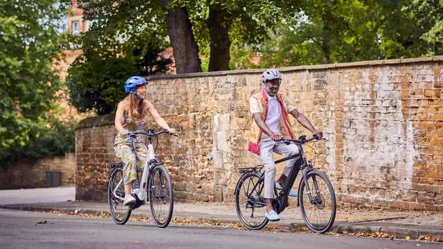 Man and woman riding Raleigh bikes