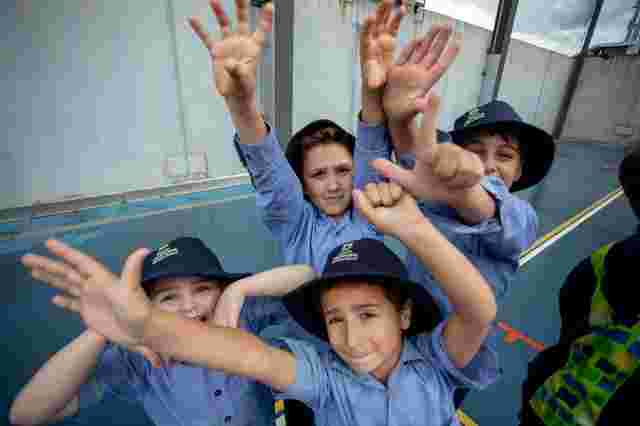 Kids throwing hands in front of camera