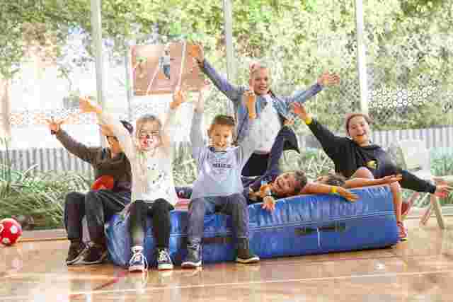 kids with arms thrown in the air