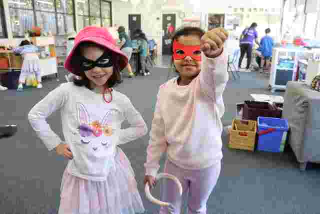 2 girls with masks posing for the camera