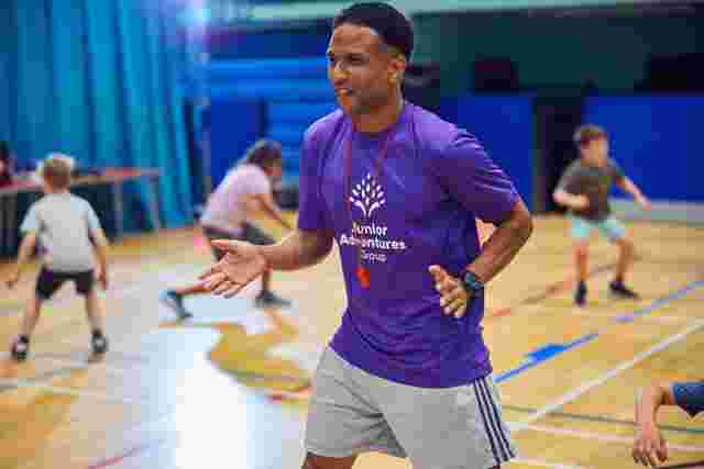 JAG staff dancing in a sports hall