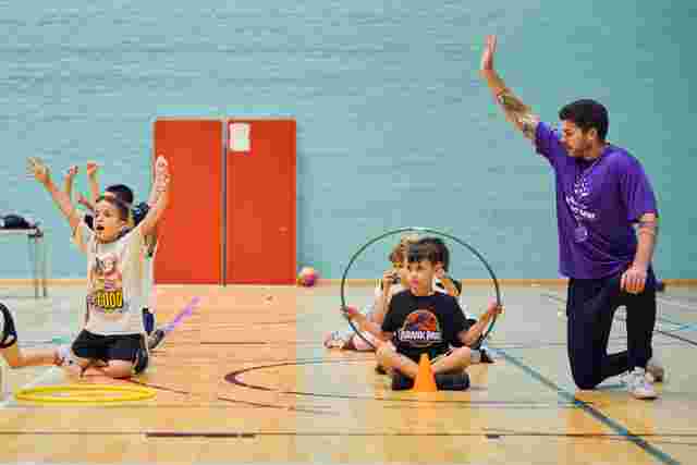 JAG staff and children in a sports hall