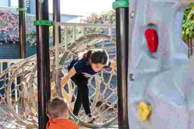Kids climbing through an obstacle course