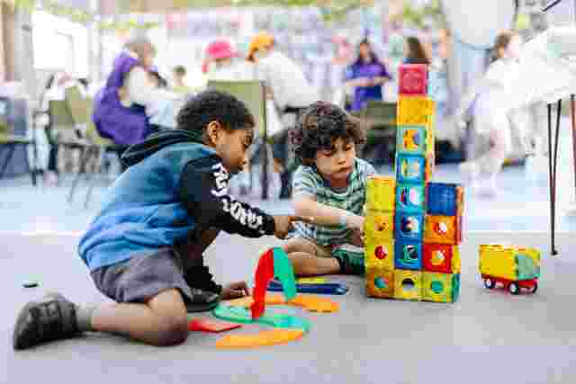 Kids building a magnetic block tower