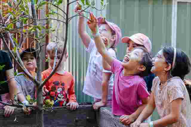 kids outdoors planting pots