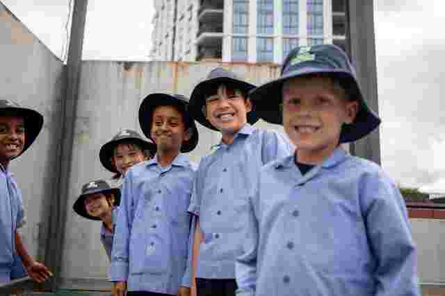 Kids in uniform posing for a photo outdoors