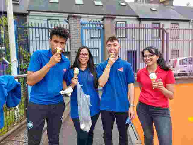 staff posing for a photo while eating ice cream