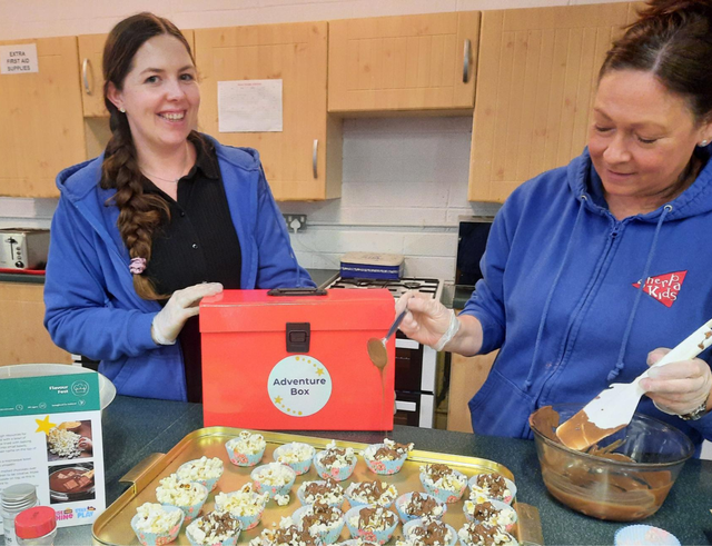 staff baking posing for a photo with the adventure box