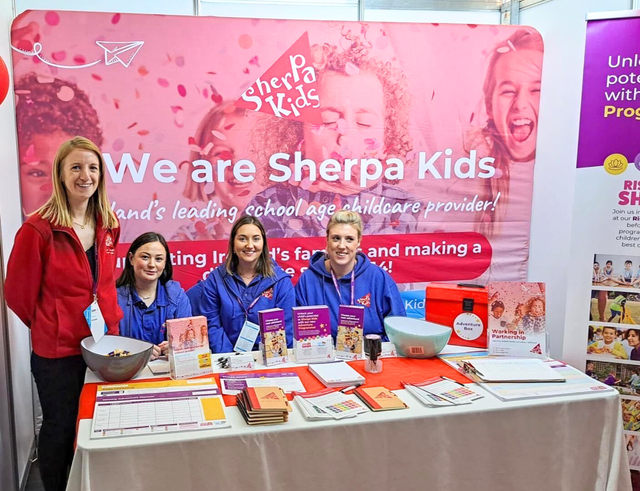 Staff at an exhibition posing for a photo