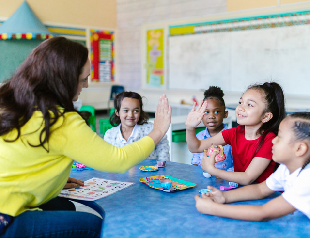 Kids and educator high five