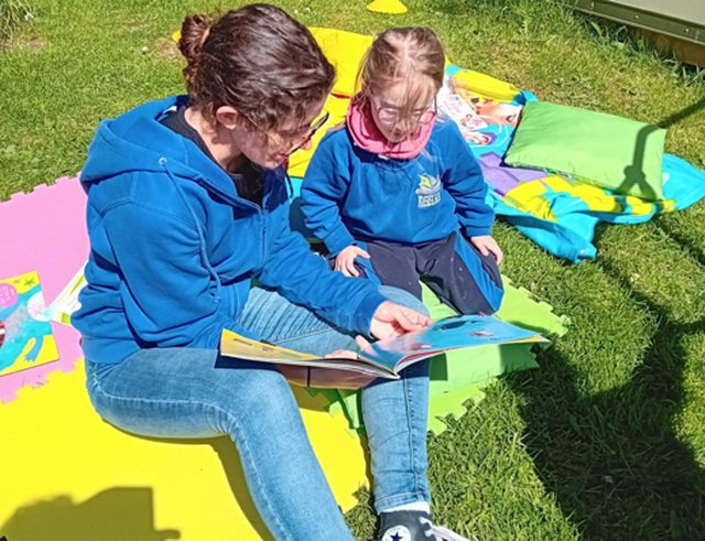 Programme Coordinator reading to a child