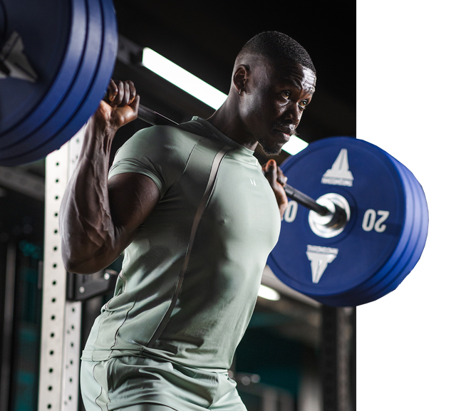 a man lifting weights in Everlast Gyms BACKBONE group training weight lifting class