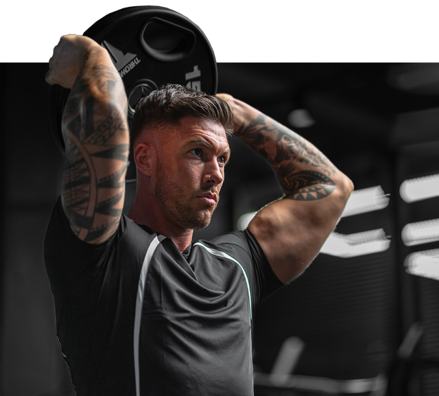 A man lifting a weighted plate over his head