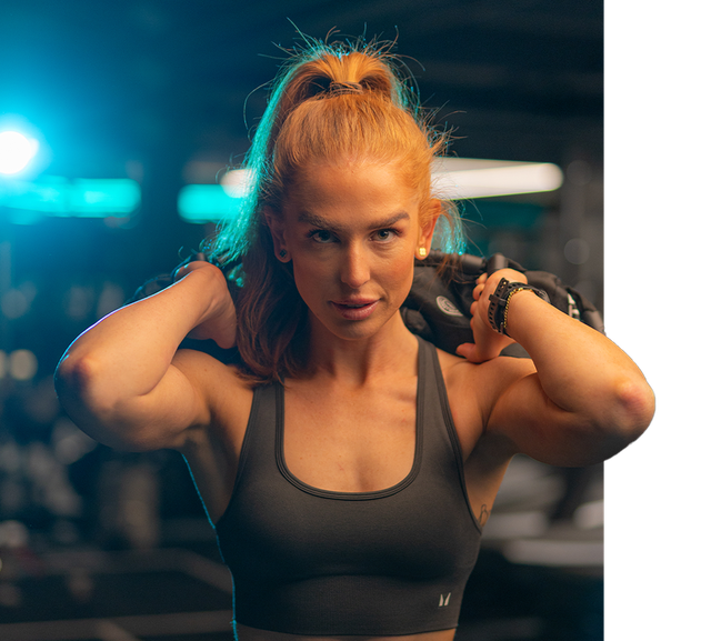 A women training HYROX in the UK's official HYROX Performance Center with Centr sandbags and Myprotein clothing