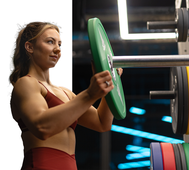 A women wearing Myprotein Clothing adding weight on to a bar bell on an Olympic Lifting Platform
