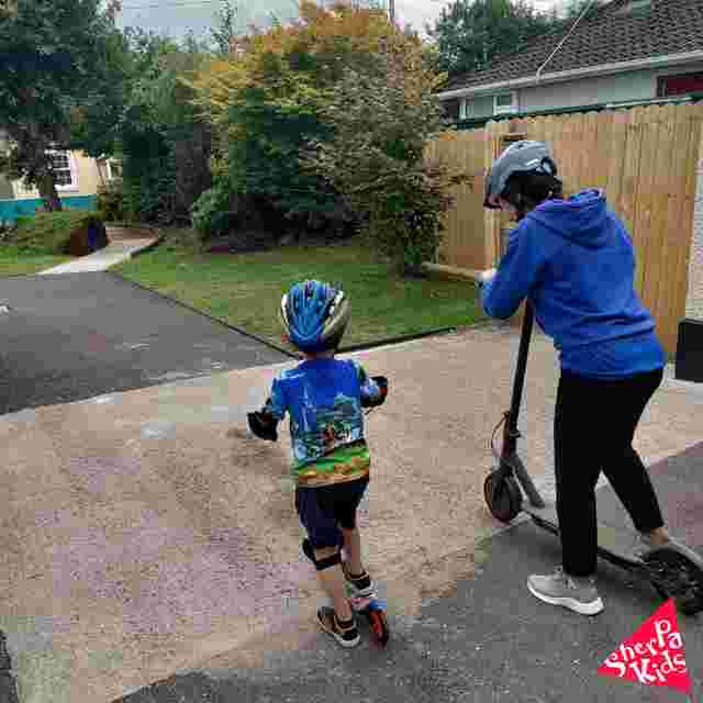 staff with a child on scooters