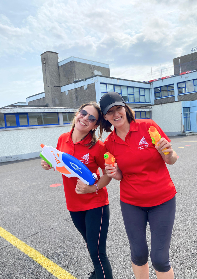 Staff with water guns smiling for a photo