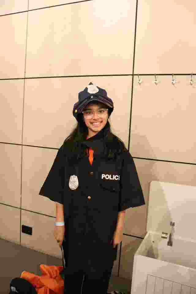 young girl dressed as a police