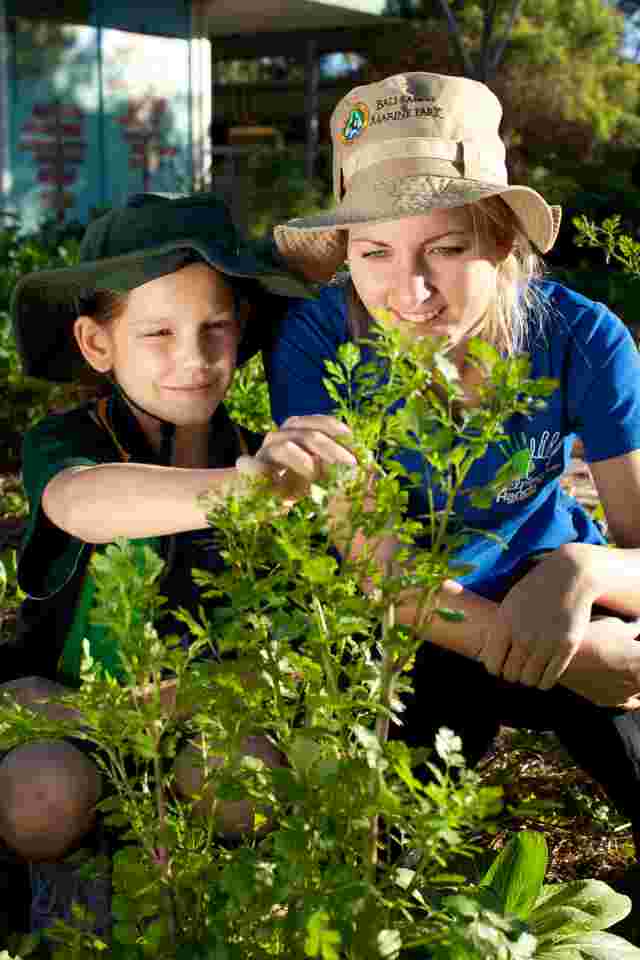 educator and kid with plant
