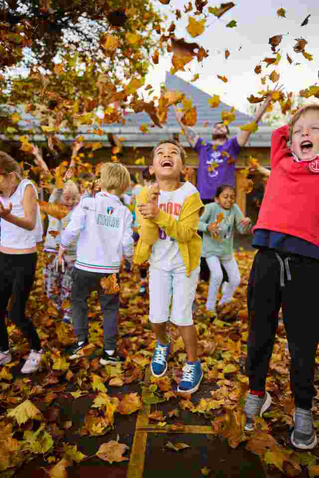 Group shot children playing in leaves