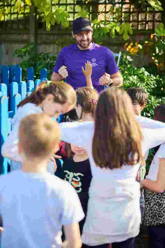 Children lining up with staff member