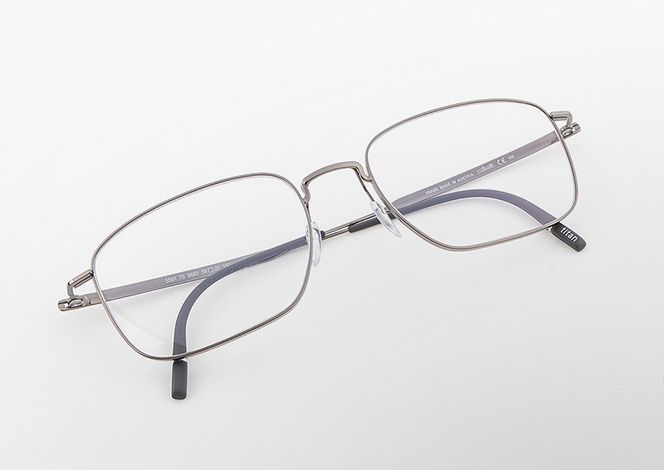 Pure Visionary titanium eyeglasses with a thin profile wire frame, geometric square lenses, and a sculpted bridge.