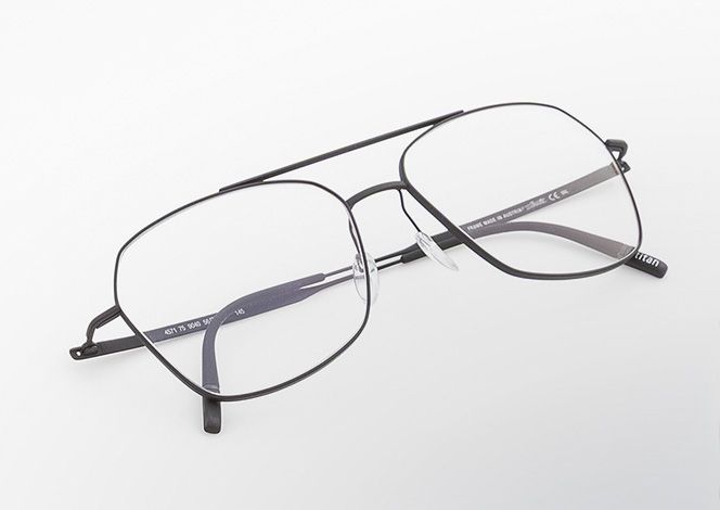 Pure Visionary titanium eyeglasses with an ultra-thin profile wire frame, softly geometric lenses, and a refined double bridge,