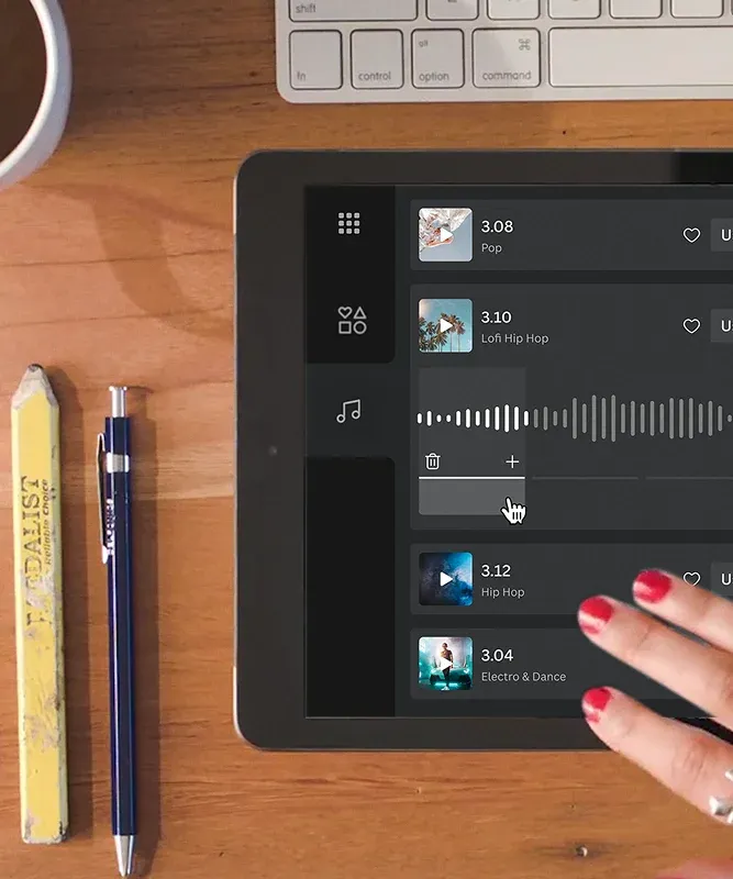 Hand selecting a track on a tablet displaying an audio interface, demonstrating Canva's in-platform licensed music API.