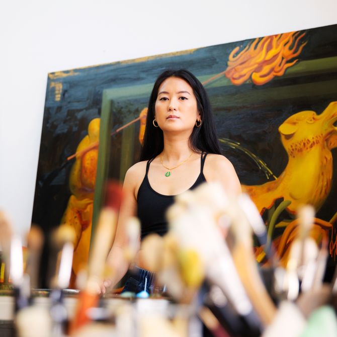 Dominique Fung standing in front of her painting 
