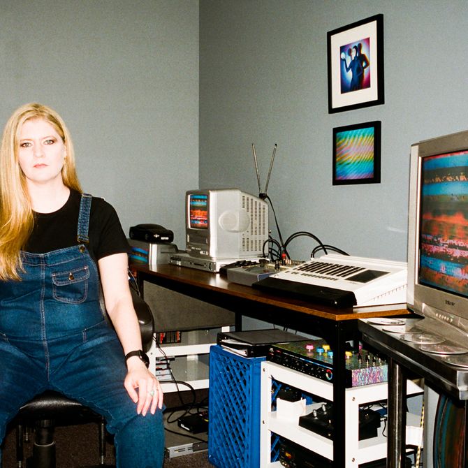 Sarah Zucker sitting in her studio next to her desk