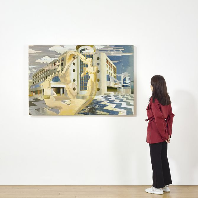 woman looking at architectural painting in a gallery