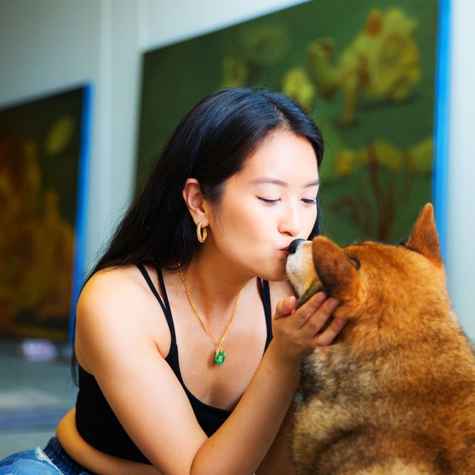 Dominique Fung kisses her dog
