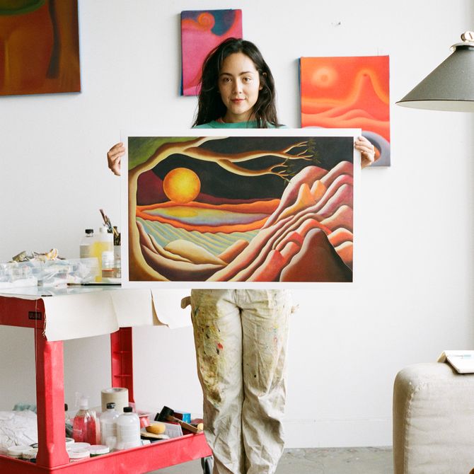 Camilla Engström a small painting of a sunset her studio