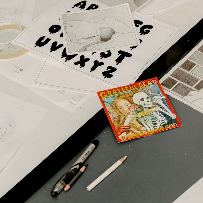 Studio desk, with drawings and art supplies