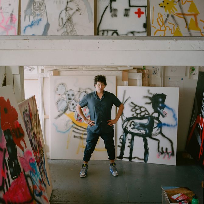 Robert Nava standing in his studio with his hands on his hips