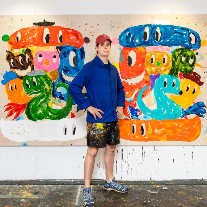 Szabolcs Bozo standing in front of a large painting