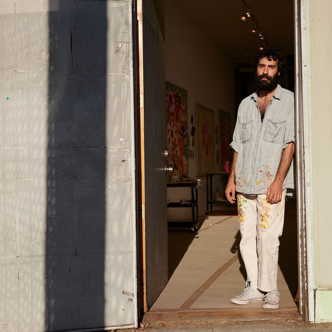 Pedro leaning in a doorway, the entrance to his studio