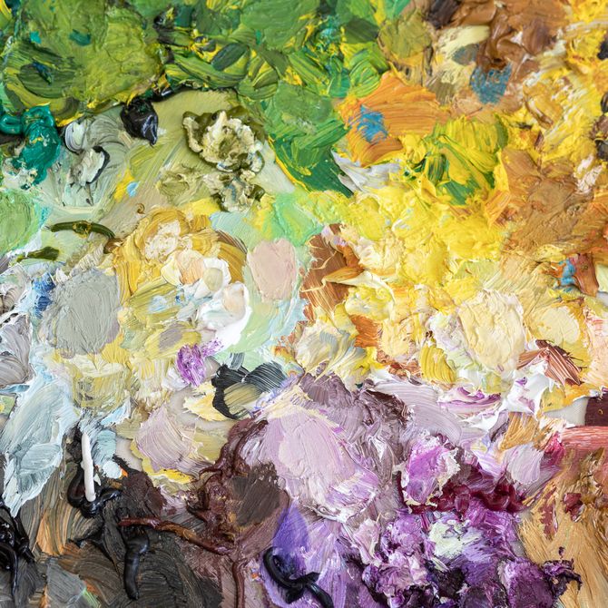layers of oil paints piled up on a board